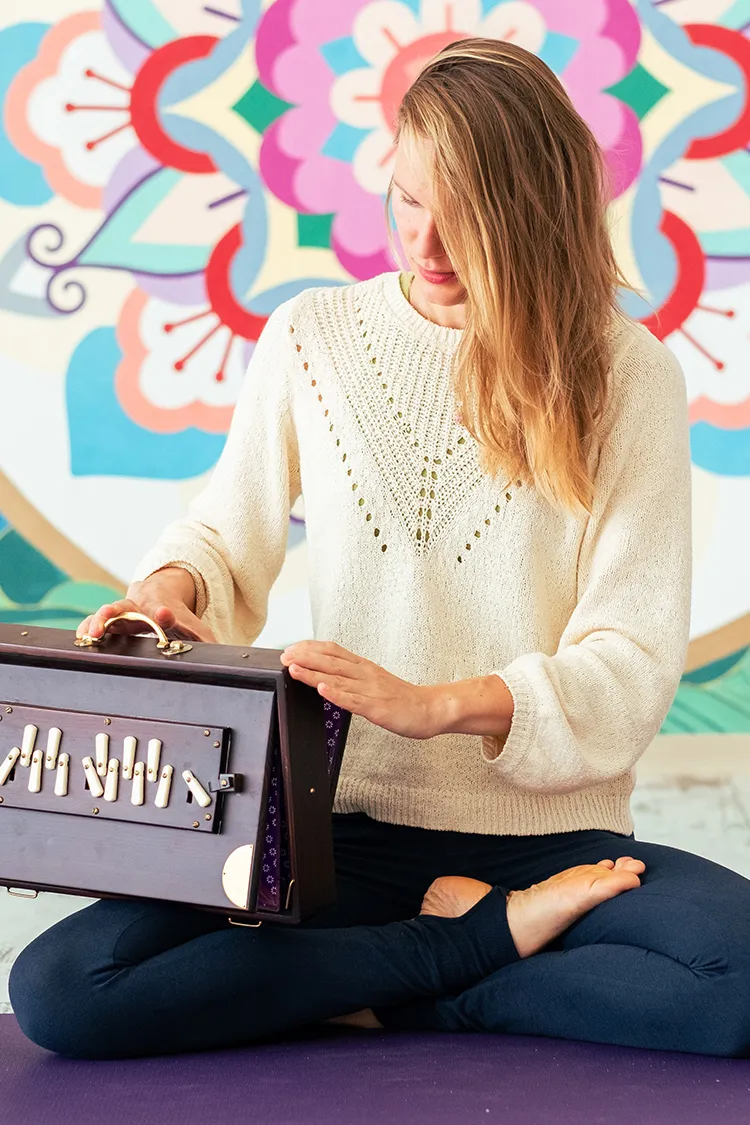 Lidiya playing a shruti box in the Om Dome, Suryalila