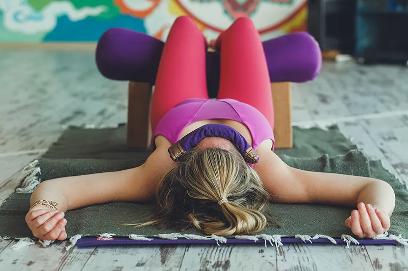 Yoga practitioner in a restorative yoga pose